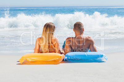 Cute couple in swimsuit sunbathing together