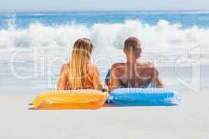 Cute couple in swimsuit sunbathing together