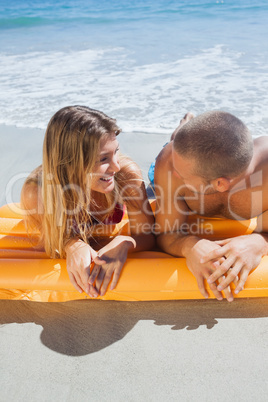Happy cute couple in swimsuit looking at each other