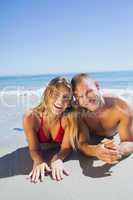 Smiling cute couple in swimsuit posing
