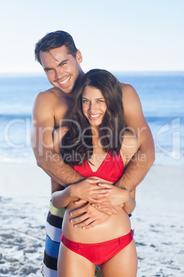 Happy couple in swimsuit hugging