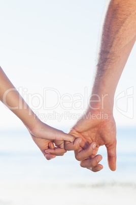 Loving young couple holding hands