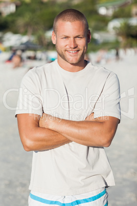 Handsome happy man in swimsuit and tshrt posing