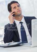 Thoughtful businessman having a phone call