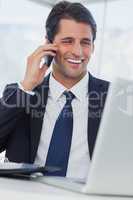 Smiling businessman having a phone call