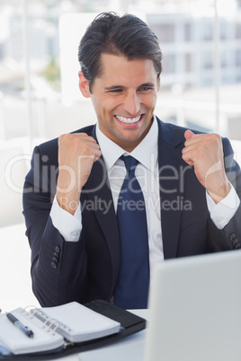 Successful businessman looking at his laptop