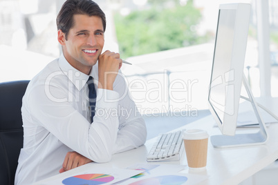 Cheerful businessman working on his computer