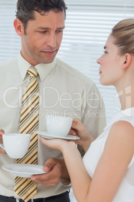 Stylish colleagues having coffee together