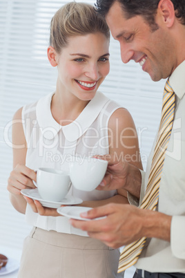 Attractive businesswoman laughing with her colleague