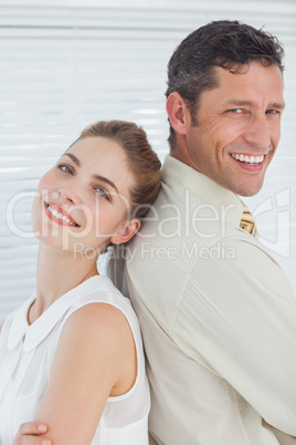 Attractive happy business team posing back to back