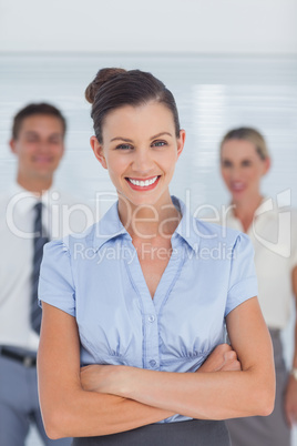 Smiling businesswoman posing with arms crossed