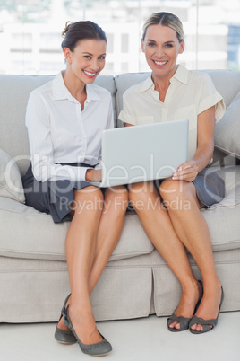 Smiling businesswomen working together posing
