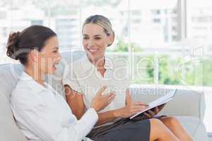 Smiling businesswomen talking and working together