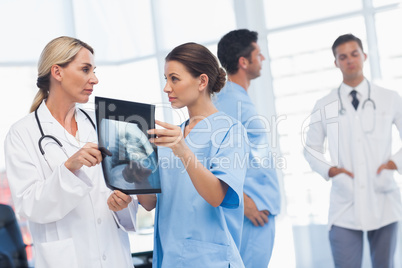 Surgeon and doctor analyzing x-ray together