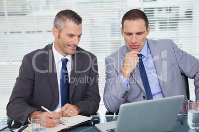 Serious businessmen analyzing application