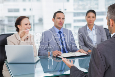 Work team interviewing experienced man