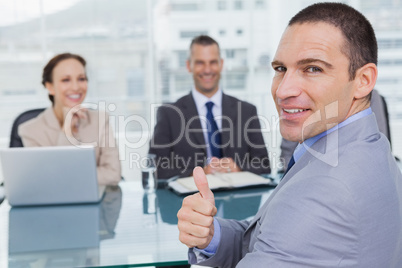 Applicant giving thumb up after obtaining the job