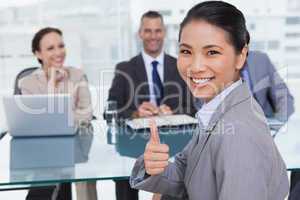 Young applicant giving thumb up after obtaining the job