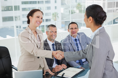 Young pretty applicant shaking hands with future employers