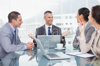 Smiling business people working together over coffee