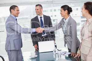 Cheerful business people meeting and shaking hands