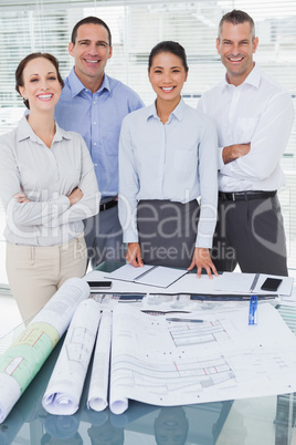 Happy architects posing while working together