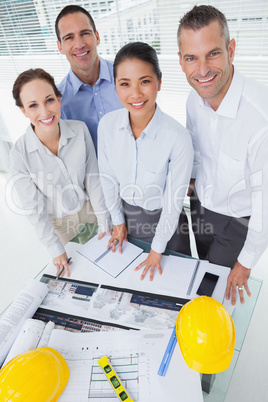 Smiling architect team posing while working together