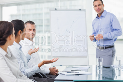 Businesswoman asking question during presentation