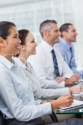 Cheerful workmates attending presentation