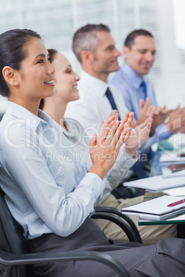 Cheerful employees applausing after presentation