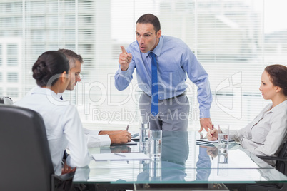 Angry executive pointing out his employee