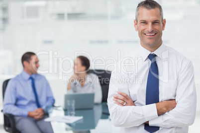 Smiling businessman posing crossing arms