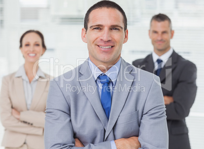 Employee posing with his colleagues on background