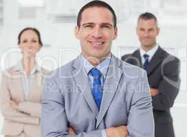 Employee posing with his colleagues on background