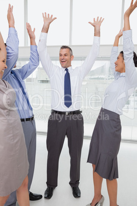 Work team cheering together