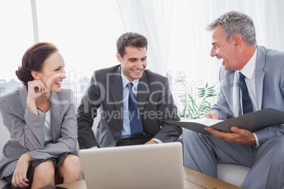 Business people laughing while having a meeting