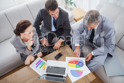 Business people analyzing diagrams together