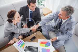 Business people shaking hands while working