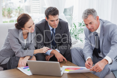 Business people analyzing financial graphs of their company