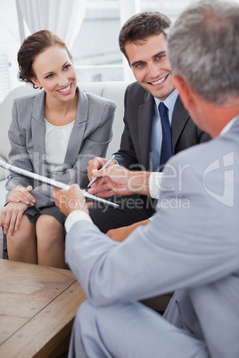 Businessman giving a contract to his partners