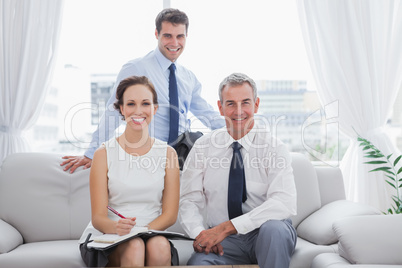 Cheerful partners posing while having a meeting