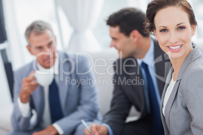 Cheerful businesswoman having a meeting with her colleagues