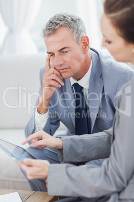 Smiling businessman working with his colleague