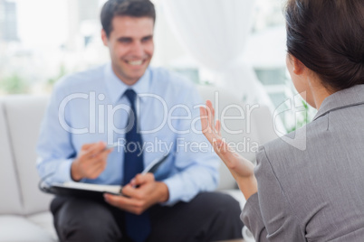 Smiling businessman talking to his colleague