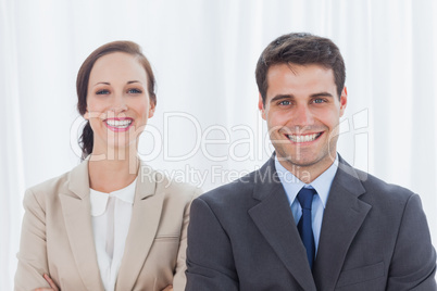 Cheerful partners posing together looking at camera