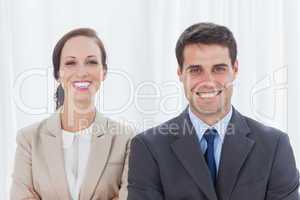 Cheerful partners posing together looking at camera