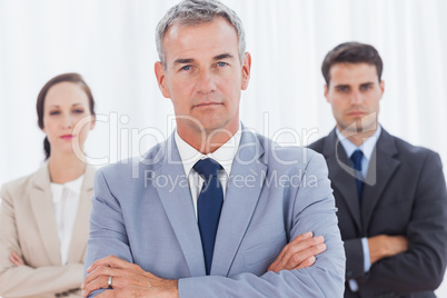 Serious businessman posing with his work team