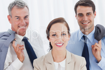 Smiling employee posing with her work team