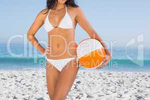 Sexy body in white bikini with beach ball