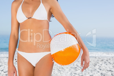Sexy female body in white bikini with beach ball